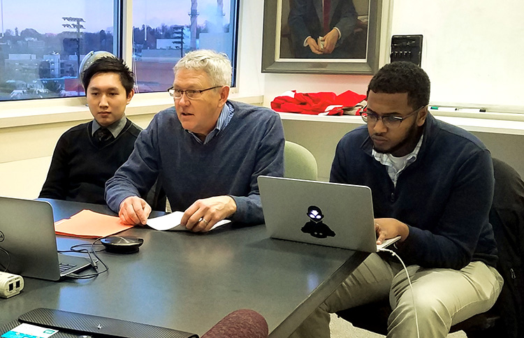 Professor Dave Kreling works with students on a business plan development project