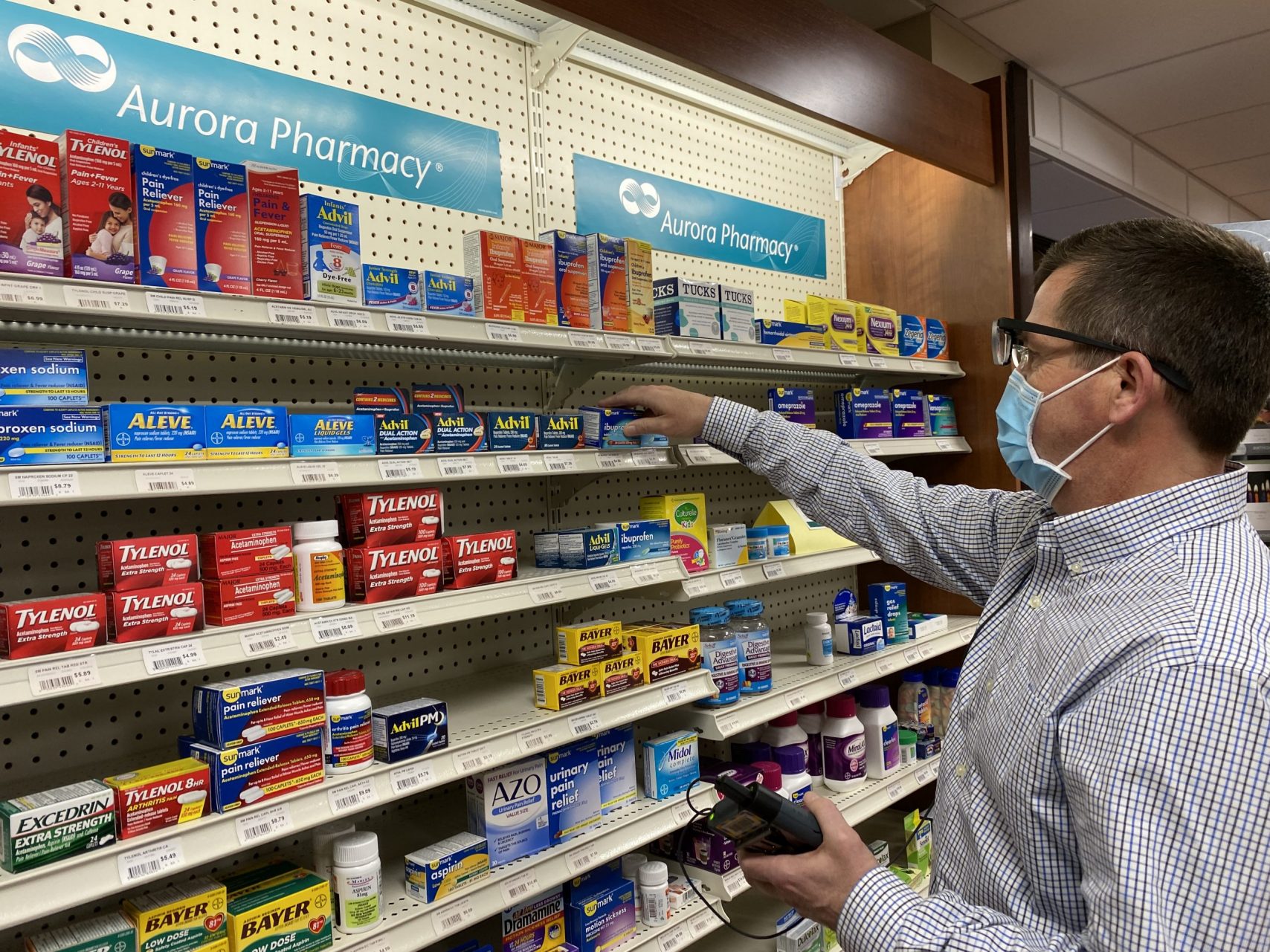 A customer looks at OTC medications in a pharmacy