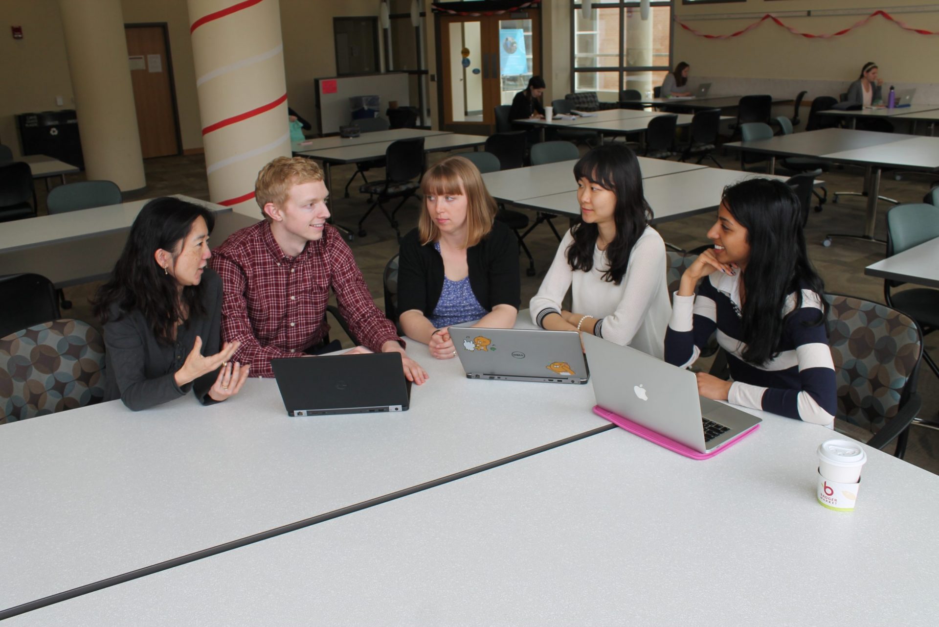 Dr. Michelle Chui, Corey Lester, and Jamie Stone at a table mentoring students