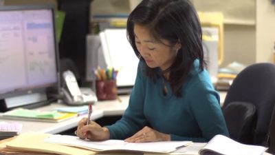Michelle Chui working on papers at her desk