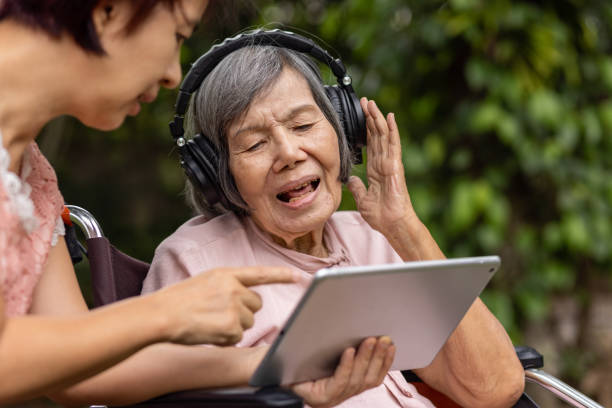 older woman with headphones on