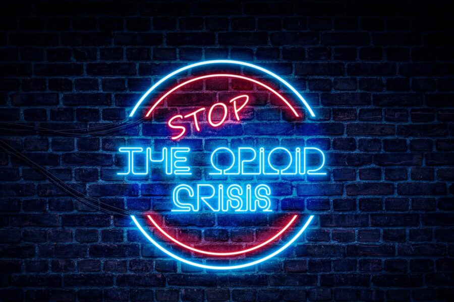 neon sign saying Stop the Opioid crisis