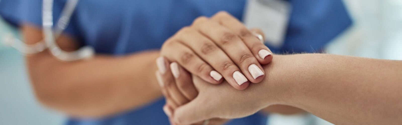female doctor holding someone's hand