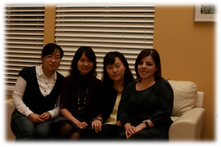 Four Hong research members sitting on a couch together during Thanksgiving