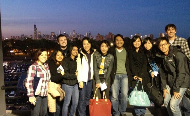 Hong Research members taking a group photo with a city skyline in the background