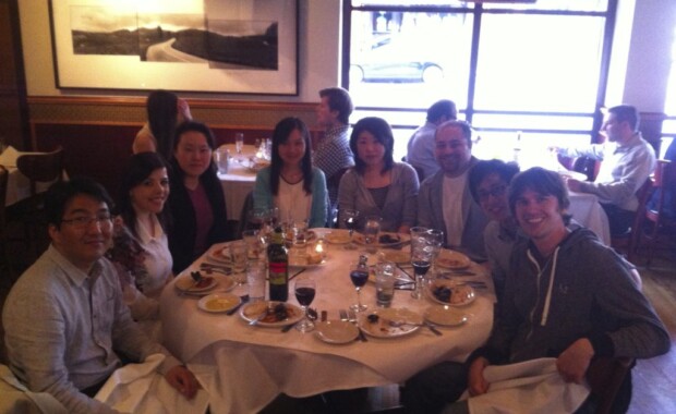 Hong Research members crowded around a table eating dinner at Francesca's
