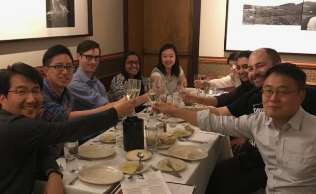 Hong Research members toasting at a restaurant