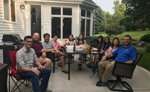 Hong Research members eating food on a patio in someone's backyard