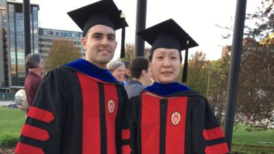 Prof. Jiayang Jiang and Matthew Worth in graduation caps, hoods, and gown