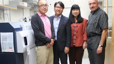 The Pharmaceutical Sciences Division (Glen Kwo, Seungpyo Hong, Lingjun Li, and Sandro Mecozzi) standing in a pharmaceutical lab together