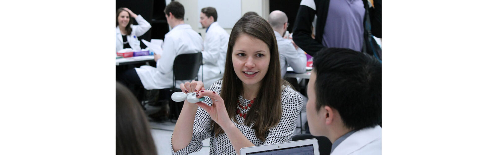 Resident showing pharmacy student an inhaler