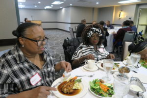 Participants in Dr. Shiyanbola's "African Americans' Perception of Type II Diabetes" study, eating at her dissemination dinner