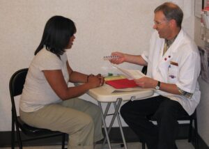 Pharmacist and patient discussing medication adherence