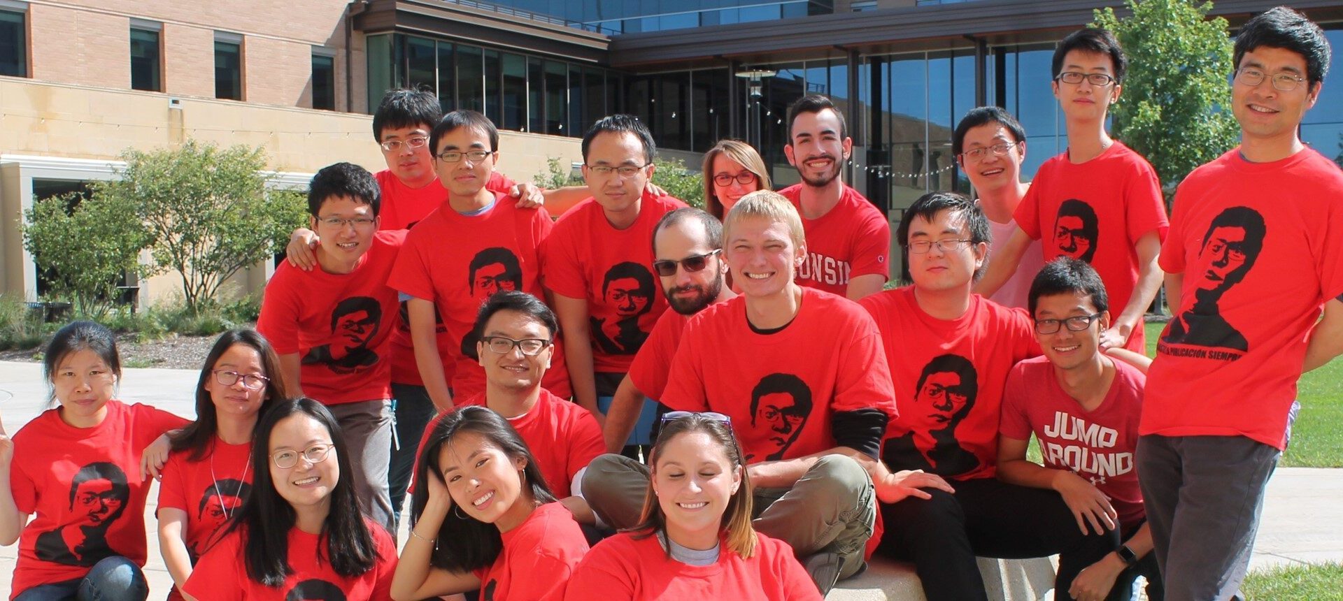 Tang Research members all wearing matching red shirts with Prof. Tang printed on the front