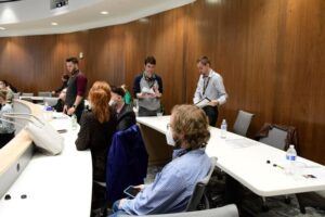 Wenthur Lab members sitting at a table for a medicinal chemistry conference