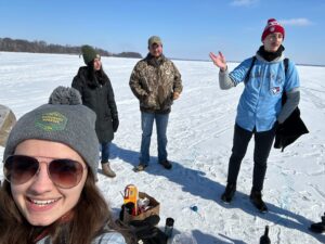 Wenthur Lab members wearing coats and standing on Lake Mendota in winter