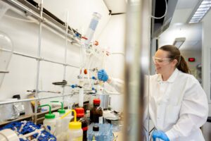 A lab person working in the hood