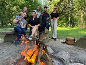 Wenthur lab members standing for a group photo behind a fire at picnic point