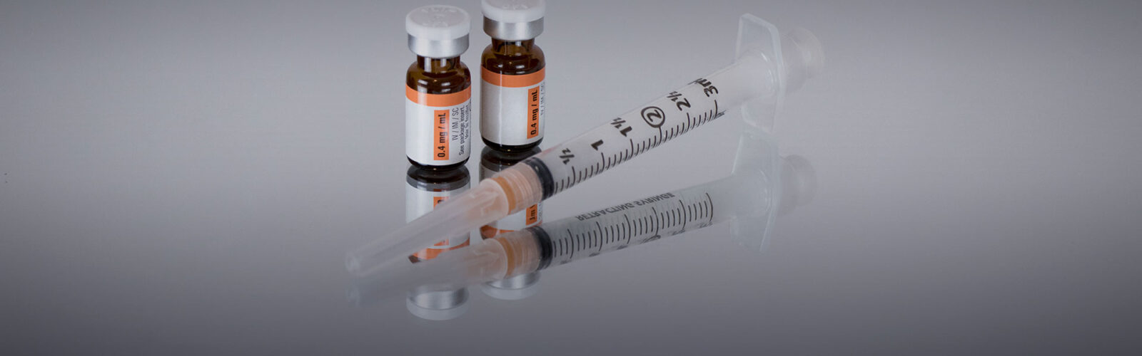 stock photo of syringe and 2 vials