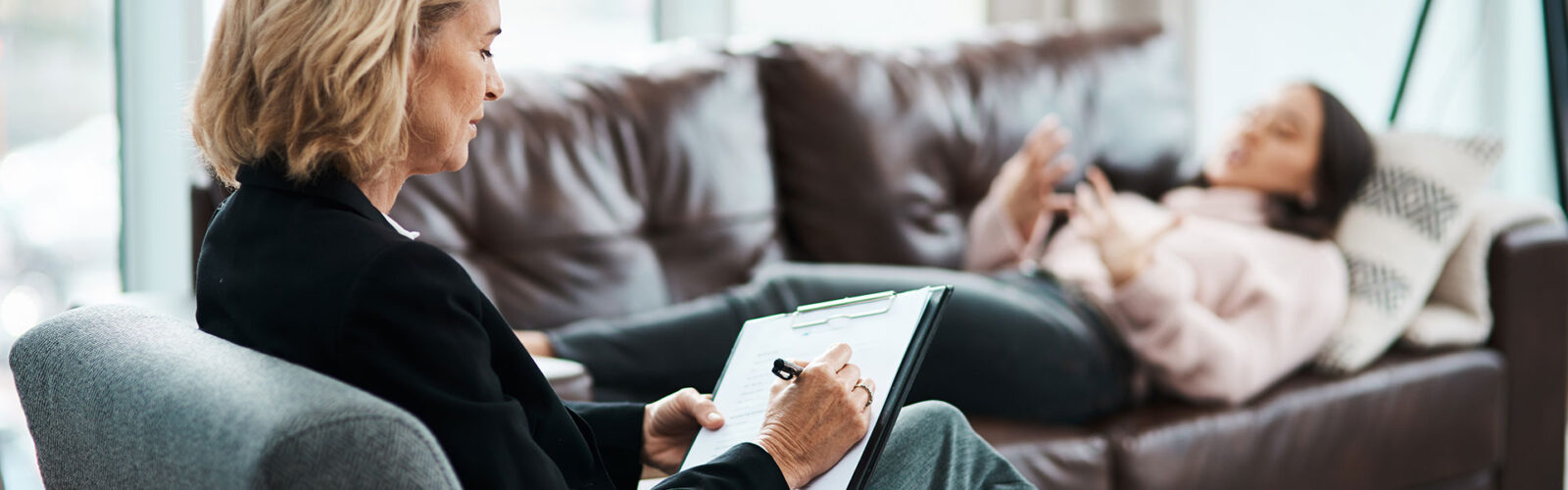 therapist in chair with patient on couch