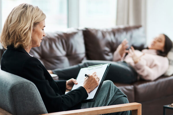 therapist in chair with patient on couch