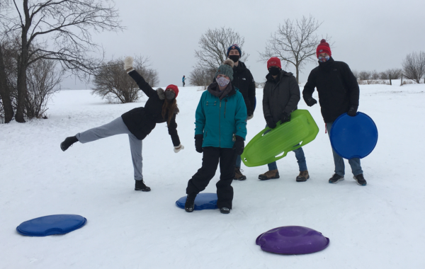 Wenthur lab members in a wintry landscape with coats and sleds