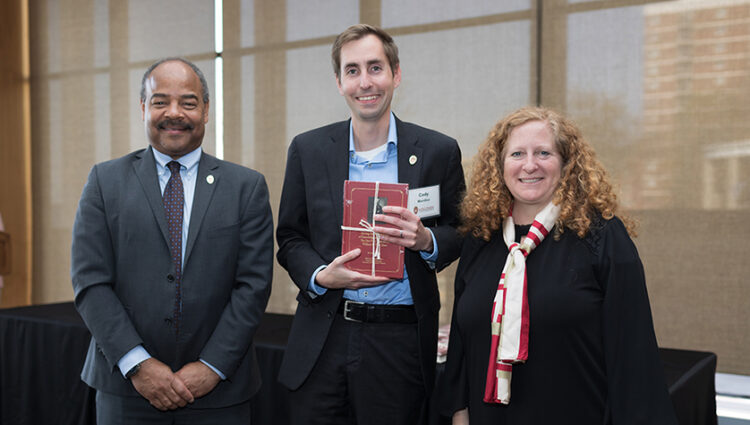 Cody Wenthur holding Vilas Award with Interm Provost Eric Wilcots and Chancellor Jennifer Mnookin