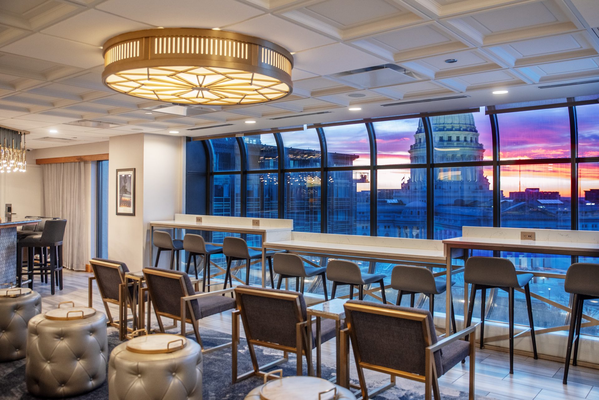 A view of the Concourse Hotel's bar, with a view of the State Capitol building just outside the window