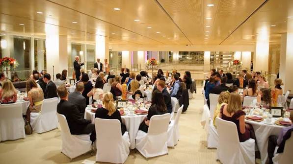 A view of the Overture Center's Promenade Hall, with guests seated at large dining tables