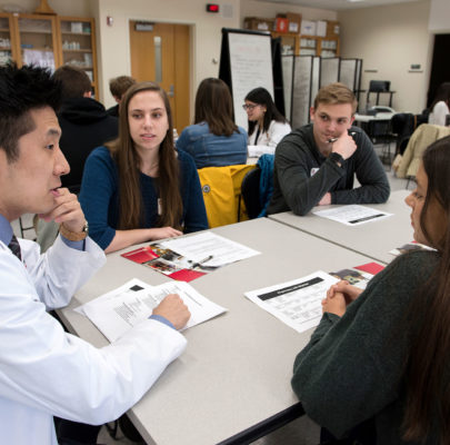 A second-year pharmacy student meets with prospective students to discuss the PharmD program