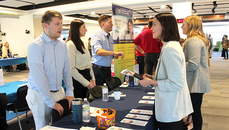 A VA Hospital rep answers a question for a third-year pharmacy student