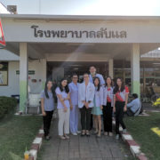 A UW-Madison pharmacy student stands with site staff members at a pharmacy in Thailand