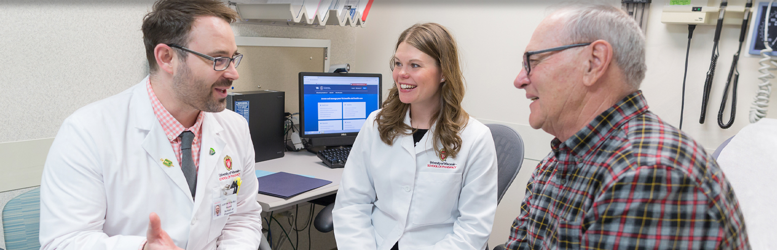 Professor Andrea Porter looks on as a third-year pharmacy student counsels a patient in clinic