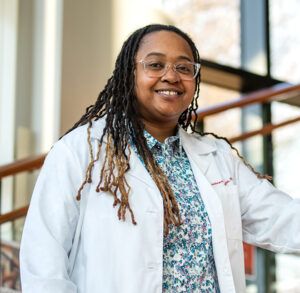 PharmD alumna Treashure Wade poses on the staircase at her clinic