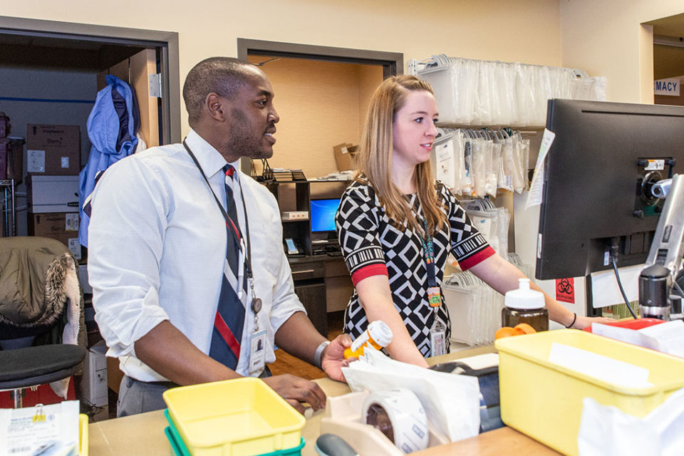 Hussain Harun (PharmD '12) and Abigail Moore (PharmD '17), are pharmacists at the House of Wellness in Baraboo, Wisconsin