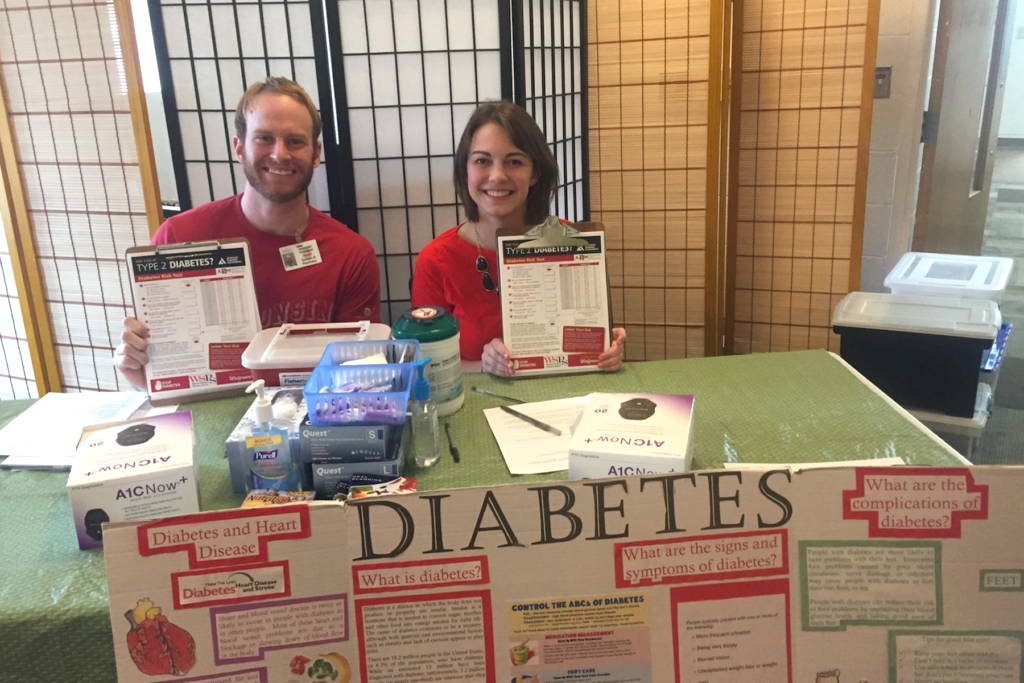 PharmD students Gregory Kuhlman and Maren VanMieghem sit at a Diabetes educational booth