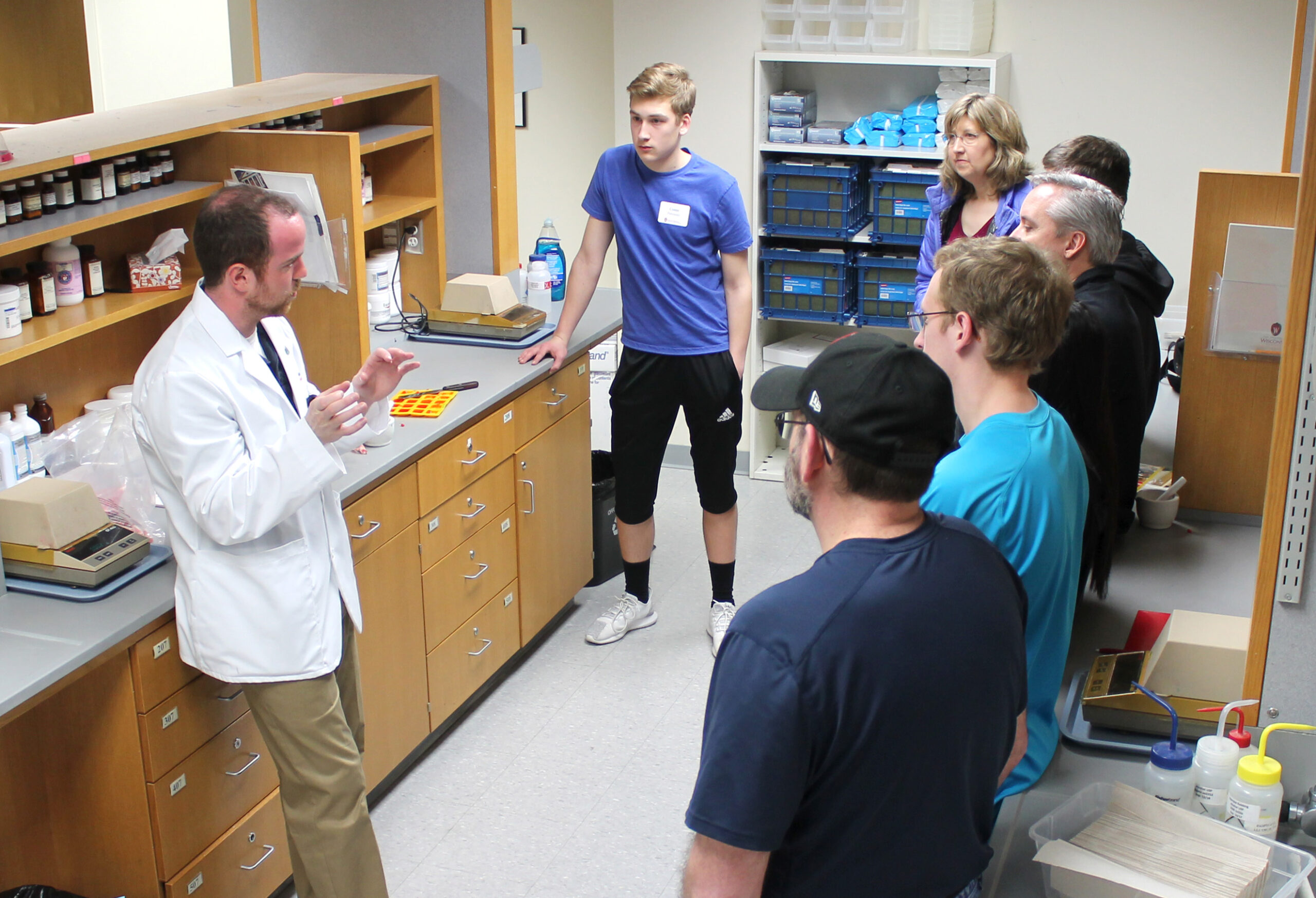 A PharmD student shows visiting families the compounding lab