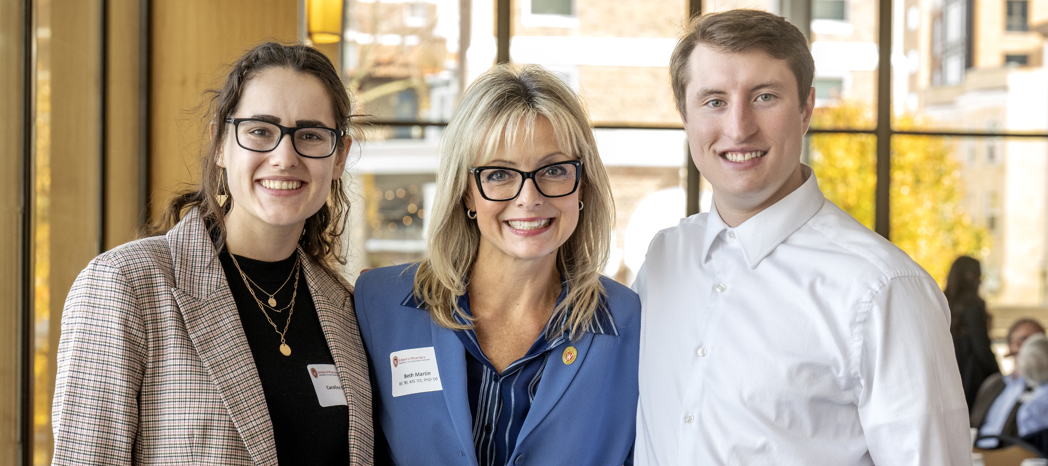 Professor Beth Martin stands with two scholarship recipients