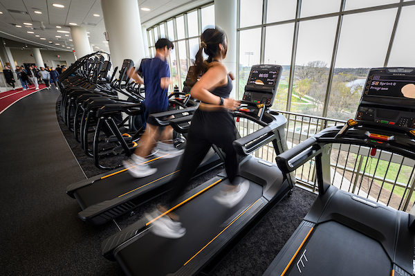 Students take a first run on the treadmills overlooking University Bay on the forth floor of the Bakke Recreation & Wellbeing Center during its grand opening at the University of Wisconsin–Madison on April 24, 2023. Members tour the new facility, use strength and cardio equipment, skate in the Sub-Zero Ice Arena, shoot hoops in the basketball courts, participate in open recreational offerings, or take a lap around the indoor running track. (Photo by Althea Dotzour / UW–Madison)