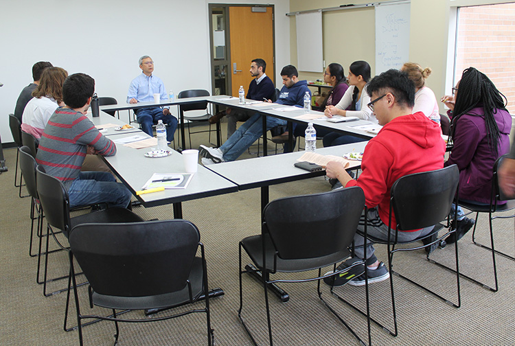 Pharmsci alum and School of Pharmacy Board of Visitors member Roger Tung gives a roundtable talk to graduate students