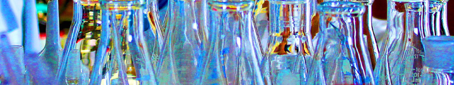 Glass beakers sparkle on a shelf