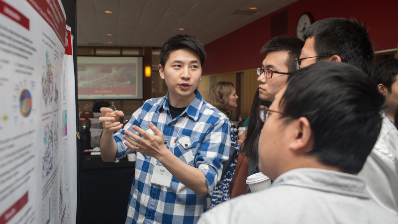 Pharmsci graduate student Hao Li explains a concept to viewers of his research poster. Photo by Scott Brown, Media Solutions
