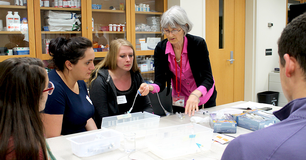 Professor Mara Kieser demonstrates how to set up a saline line
