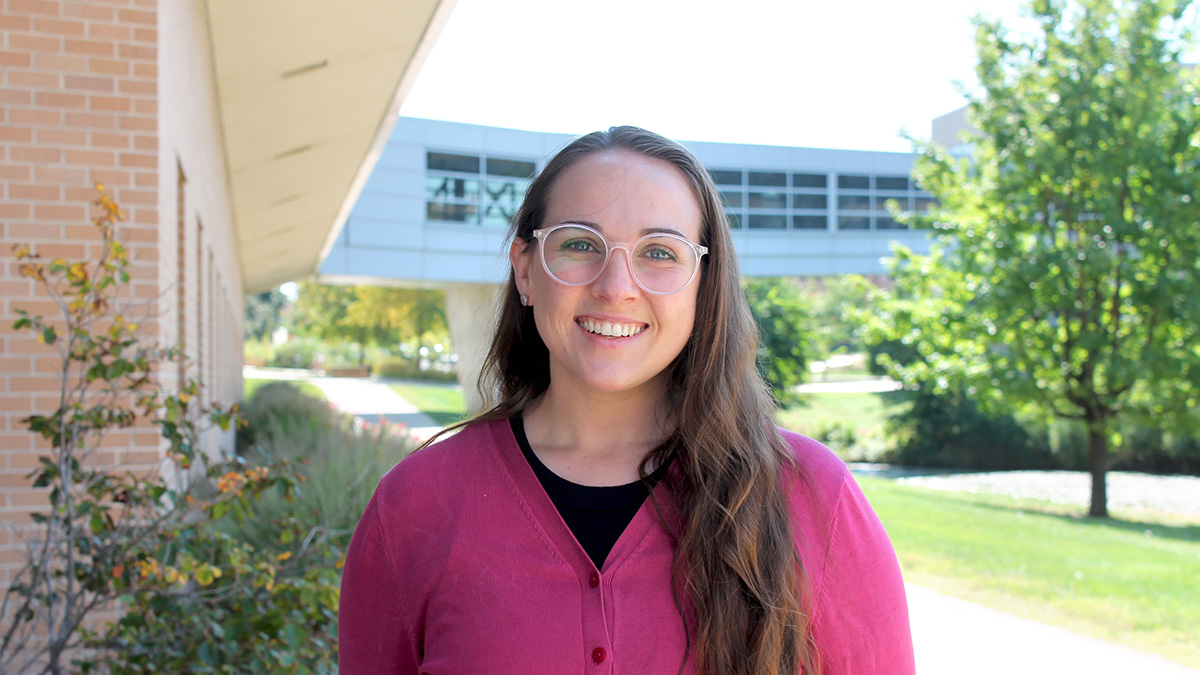 Portrait of Sara Hernandez standing by the pond outside of Rennebohm Hall