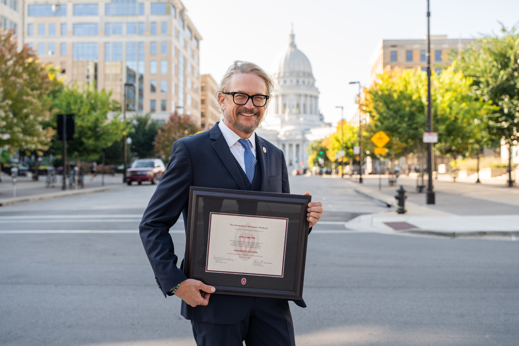 John Hill poses with his award