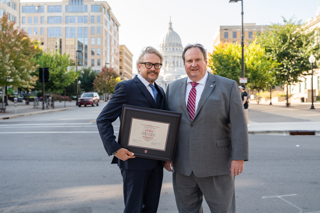 John Hill poses with his award and Steve Swanson