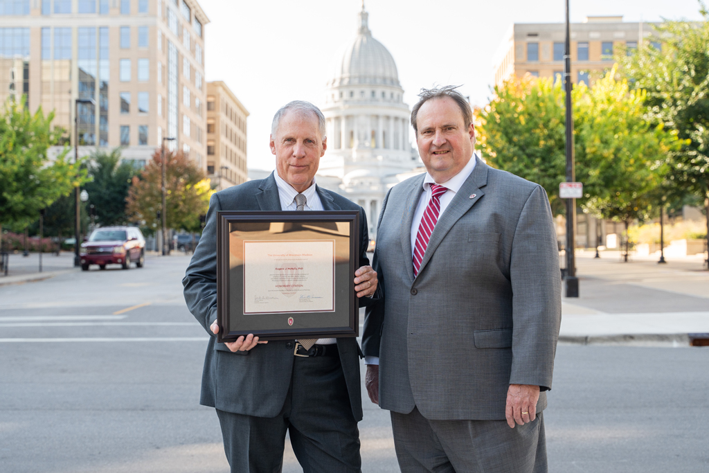 Eugene McNally poses with his award and Steve Swanson