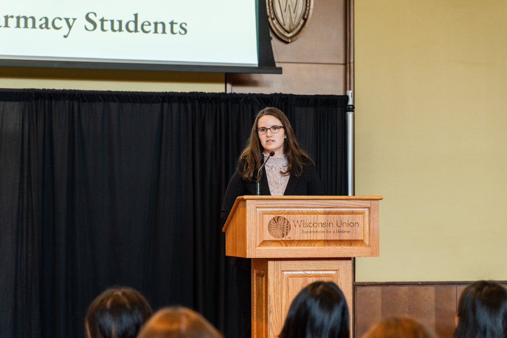 A PharmD student speaks at the podium