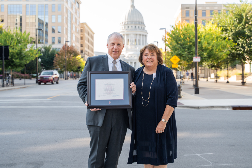 Eugene McNally poses with his award and his wife