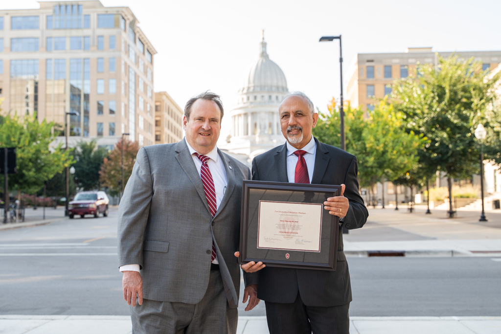 Harry Sharata poses with his award and Steve Swanson